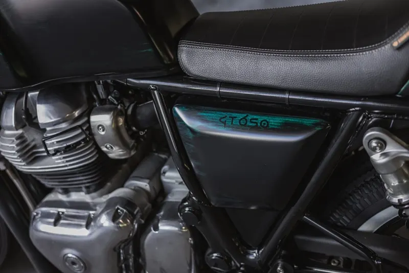 Custom Royal Enfield Continental GT 650 café racer built by Rogue Motorcycles Australia, featuring a minimalist black fairing, hand-crafted seat cowl, retro café racer styling, and premium custom finishes in a classic garage setting