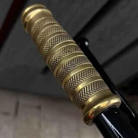 Close-up of brass handlebar grip on Royal Enfield Bullet 500 custom chopper