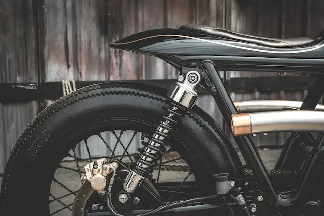 Firestone Deluxe Champion tires and handcrafted stitched leather seat on Royal Enfield Interceptor 650 Zeus Custom